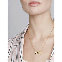 tessla: crystal tux bow gold pendant